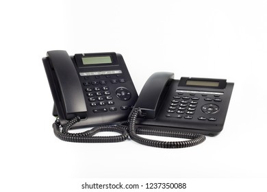 Two Black IP Phones On A White Background, Close-up.