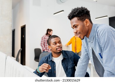 Two Black Male College Students Talk And Work Together On A College Project In A Campus Study Room. Young Entrepreneurs.