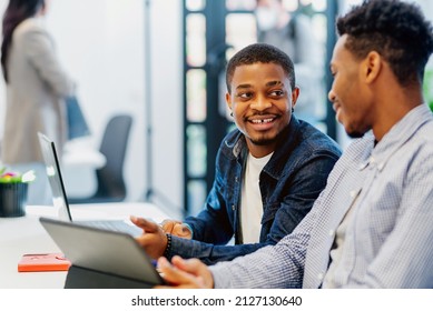 two black men work together on a project with a digital tablet in an office. two young african students on university campus - Shutterstock ID 2127130640