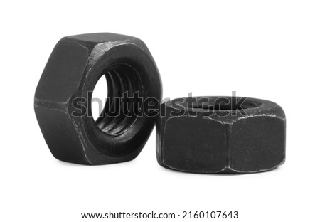 Two black metal hex nuts on white background