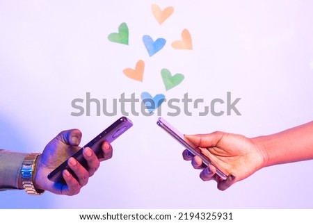 two black people using their phones with love shapes in the background, online dating concept