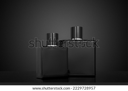 Two Black perfume bottles on a black background. Mockup of black perfume bottle                               