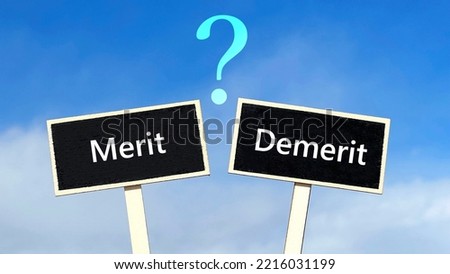 Two black plates with the letters Merit and Demerit and a question mark in blue sky background