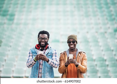 Two black race friends having fun with mobile. Friends Concept