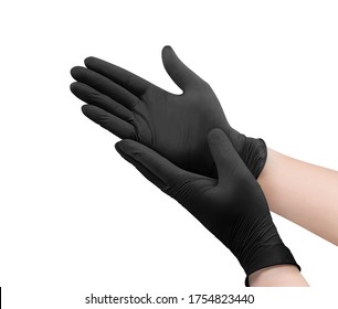 Two black surgical medical gloves isolated on white background with hands. Rubber glove manufacturing, human hand is wearing a latex glove. Doctor or nurse putting on nitrile protective gloves