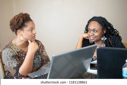 Two Black Women Doing Work On Laptops