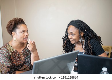 Two Black Women Doing Work On Laptops