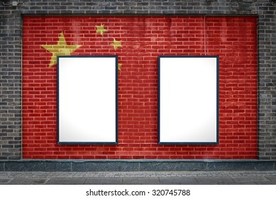 Two Blank Billboards Attached To A Buildings Exterior Brick Wall Which Has A China Flag Painted On It.