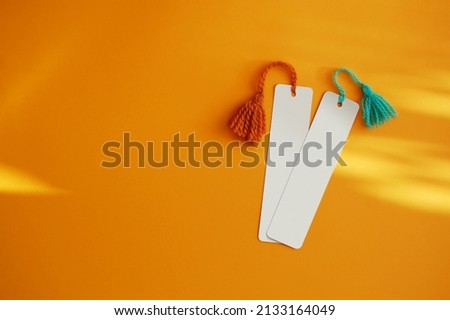 Two blank bookmarks on orange background.