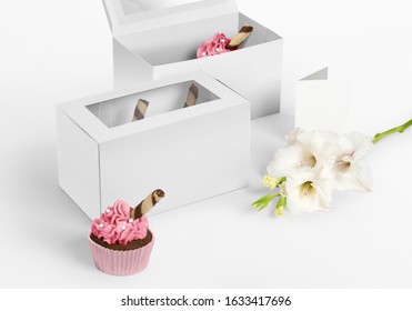Two blank cupcake boxes with blank greeting and flower on isolated background