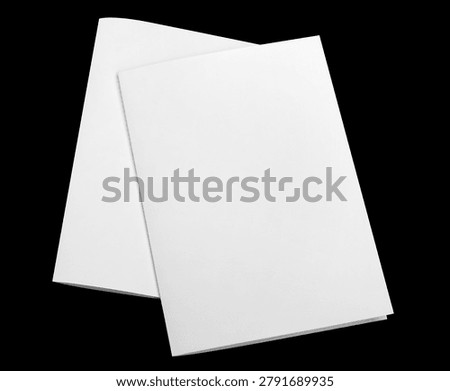 Two blank folded paper sheets, isolated on black background