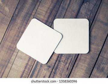 Two Blank Square Beer Coasters On Vintage Wooden Background. Flat Lay.