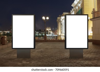 Two Blank Street Billboards At Night. Isolated With Clipping Path Around Advertising Display. 3d Illustration.