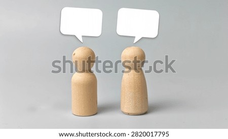 Two Blank White Speech Bubbles Above Wooden Dolls Representing Conversation Communication Dialogue Discussion Feedback and Copy Space Concept. 