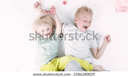 Similar – Image, Stock Photo Child laughing joyfully while making a snow angel, dressed in a vibrant winter coat and hat