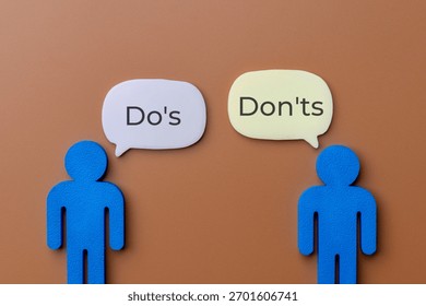 Two blue figures with speech bubbles discussing Do's and Don'ts. Rules, guidelines, right versus wrong, and business compliance or advice concept.