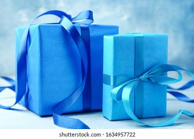 Two blue gift boxes with ribbons for celebration, holiday, and special occasion presents