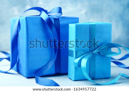 Two blue gift boxes with ribbons for celebration, holiday, and special occasion presents