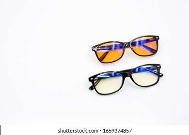 Two Blue Light Blocking Glasses (yellow And Orange Lenses) Isolated On White Background