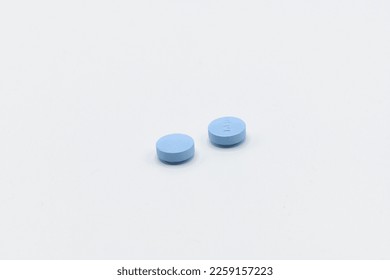 Two blue pills on a white background - Shutterstock ID 2259157223