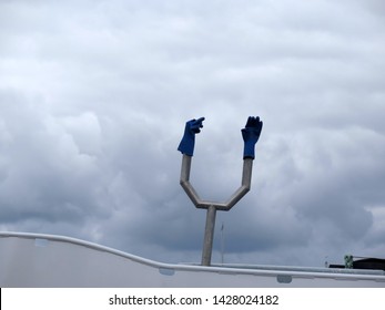 Two Blue Plastic Gloves On Metal Contraption On Fishing Boat In Southern Danish Harbour