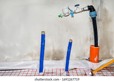 Two Blue Plastic Pipe With Cold Water Coming Out Of The Floor And Valve From The Main Water Supply, Home Water System.