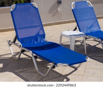 Two blue sun loungers in a hotel near the hotel