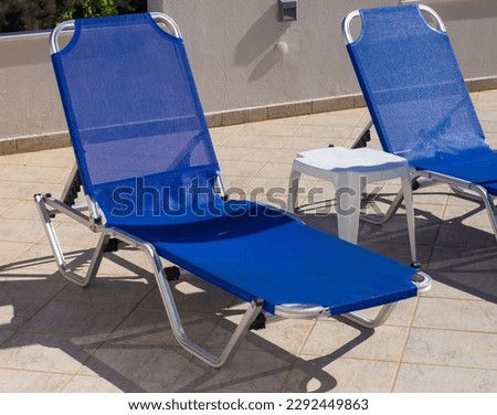 Two blue sun loungers in a hotel near the hotel