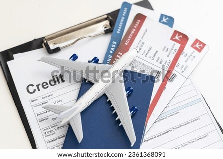 Two boarding passes with a white model airplane on a laptop keyboard. An idea about aviation or ticket reservation nowadays can be done easily online at hand by using web browser and the internet.