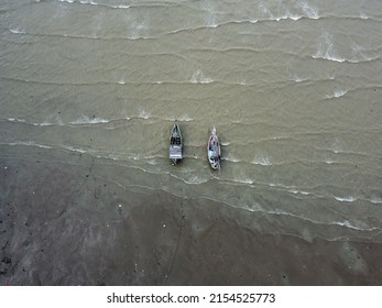 Two Boat Tongkang Anchored In The Dirty Beach