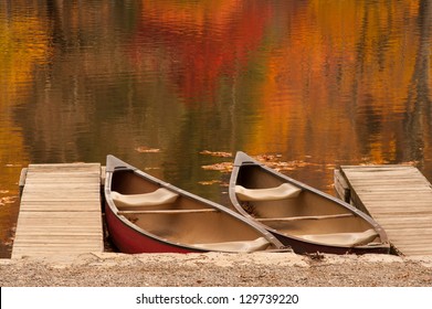 Two boats or canoes sitting in a lake during the peak of autumn in the North Carolina mountains. - Powered by Shutterstock