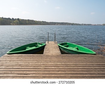 two boats at the dock on a lake