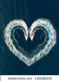 Two Boats Form A Shape Of A Heart On The Ocean Surface; Aerial Top Down View