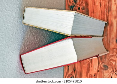 Two Books On A Wooden Table From An Unusual Angle