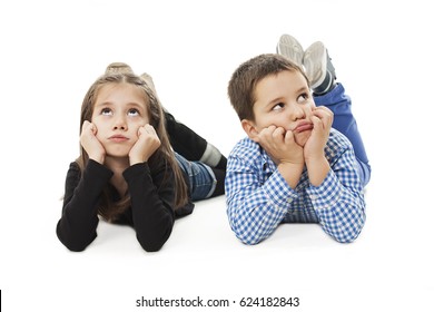 Two Bored Kids Lying On The White Background