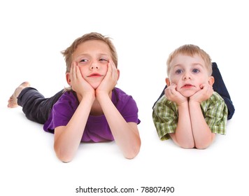 Two Bored Kids Lying On The White Background