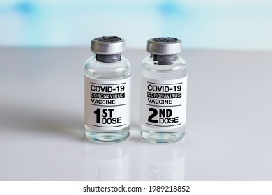 Two Bottles Of Coronavirus Vaccines With The Name First And Second Dose In The Label. COVID-19 Vaccine Vials That Require 2 Injections Tagged With 1st 2nd Dose