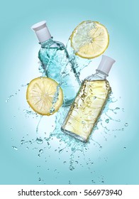 Two bottles cosmetic moisturizing lotion in the big water splash  Two lemon slices near the bottles  Turquoise gradient background