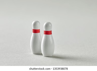 Two Bowling Pins On Grey Paper Background