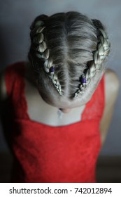 Two Boxer Braids On The Head Of A Little Girl In A Red Dress, Cl