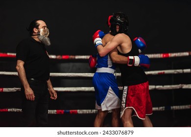 Two boxers hugging in the ring after a club fight. Sportsmanship concept - Powered by Shutterstock