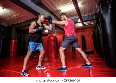 Two boxing men exercising together at the health club - Powered by Shutterstock