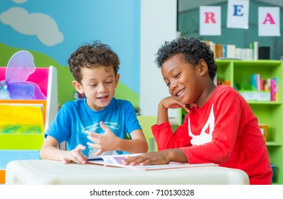 Two boy kid sit on table and reading tale book  in preschool library,Kindergarten school education concept,children day card - Powered by Shutterstock