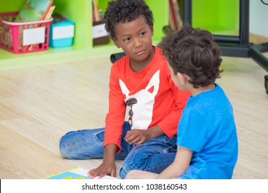 Two Boy Kid  Sitting On Floor And Taking In Preschool Library,Kindergarten School Education Concept.diversity Children