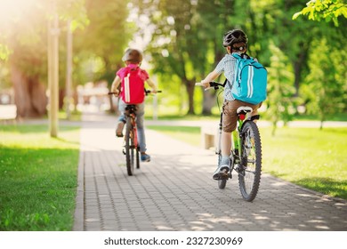 Two boys with backpacks on bicycles going to school. - Powered by Shutterstock