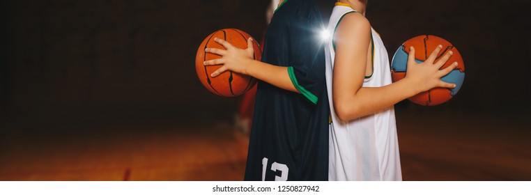 Two Boys Basketball Team Players Holding Basketballs on the Wooden Court. Basketball Training For Kids. Horizontal Background of Youth Basketball Players, Copy Space