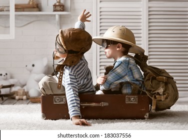 Two boys in the form of an aircraft pilot and traveler playing in her room - Shutterstock ID 183037556