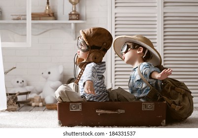 Two boys in the form of an aircraft pilot and traveler playing in her room