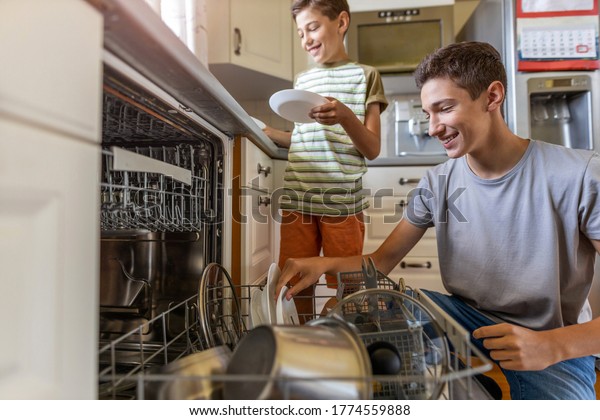 Two Boys Loading Dishwasher Together Home Stock Photo 1774559888 ...