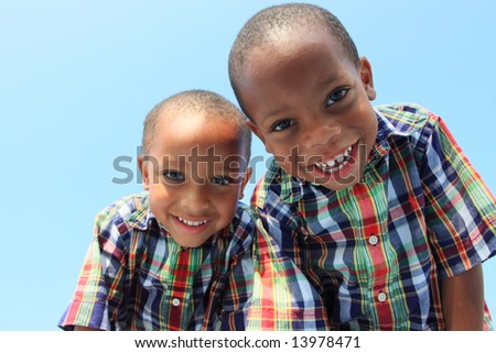 Two Boys Looking Down and Smiling
